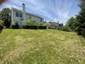 Large, grassy backyard perfect for outdoor activities featuring green grass, trimmed trees and bushes, and bright sunlight at 5920 Copeland Mills Dr, Indianapolis, IN 46221