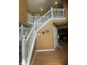 Grand foyer with a staircase features warm color walls, beautiful wood floors, and an open railing at 5920 Copeland Mills Dr, Indianapolis, IN 46221