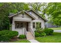 Attractive residence showcases a welcoming front porch and manicured bushes, creating a cozy curb appeal at 595 W Poplar St, Zionsville, IN 46077