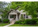 A beautiful house with a covered porch, complemented by a well-maintained lawn and mature trees at 595 W Poplar St, Zionsville, IN 46077