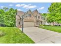 Well-maintained brick home with an attached garage and spacious driveway at 6168 Pine Bluff Dr, Avon, IN 46123