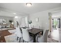 Elegant dining room featuring a dark wood table set for six, with bright natural light at 6552 Hunters S Rdg, Zionsville, IN 46077