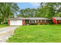 Charming brick ranch-style home with attached garage and well-maintained lawn at 7050 N County Road 650 E, Brownsburg, IN 46112
