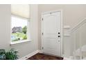 Bright foyer with staircase, window, and front door access at 7152 Cherry Creek Blvd, Carmel, IN 46033