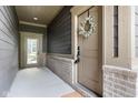Covered front porch with wreath on front door and side-door access to the property at 7152 Cherry Creek Blvd, Carmel, IN 46033