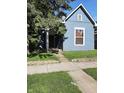 Cozy bungalow features tidy lawn, siding and shade tree at 764 Haugh St, Indianapolis, IN 46222