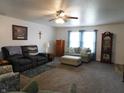 Cozy living room with natural light, ceiling fan, and plush carpeting, ready for relaxation at 8346 Weathervane Cir, Indianapolis, IN 46239