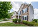 Charming two-story home with stone and siding, featuring manicured shrubs and green lawn at 8710 N Aspen Way, McCordsville, IN 46055
