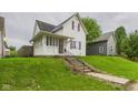 Quaint home with lush green lawn and steps leading to the front entrance at 907 S A St, Elwood, IN 46036