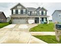 Inviting two-story home with three-car garage and well-kept lawn at 9133 Thames Dr, Avon, IN 46123