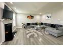 Bright living room features a plush gray sectional sofa, a modern fireplace, and stylish artwork at 9133 Thames Dr, Avon, IN 46123