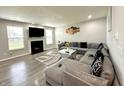 Inviting living room boasts a cozy fireplace, plush gray sofa, and modern decor at 9133 Thames Dr, Avon, IN 46123