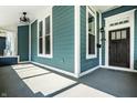 Inviting covered porch featuring painted blue wood planking and a decorative ceiling fan at 1034 N Tacoma Ave, Indianapolis, IN 46201