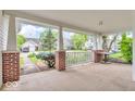 Relaxing covered front porch with brick supports and white railing, offering a cozy outdoor space at 10717 Morristown Ct, Carmel, IN 46032