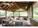 Cozy screened-in porch offering outdoor seating, ceiling fans, and views of the backyard at 11423 Atlantic Rd, Fortville, IN 46040
