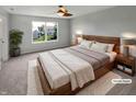 Bedroom features a ceiling fan, and a large window with natural light, creating a peaceful retreat at 11753 Pawleys Ct, Indianapolis, IN 46235