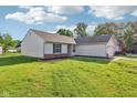 Charming home with a well-maintained lawn, showcasing its delightful curb appeal at 12250 Longstraw Dr, Indianapolis, IN 46236