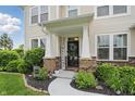 Inviting front porch with decorative columns, attractive landscaping, and a welcoming entrance at 1281 Jesse Ct, Greenwood, IN 46143
