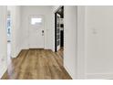 Bright foyer with hardwood flooring, white walls, and views into adjacent rooms through glass doors at 1364 Chatham Hills Blvd, Westfield, IN 46074