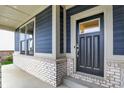 Close-up of the front entrance with brickwork, a black front door with a window, and light-colored trim at 1364 Chatham Hills Blvd, Westfield, IN 46074