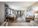 Bright living room featuring neutral walls, comfortable seating, stylish decor, and natural light at 1495 E 240 N, Anderson, IN 46012