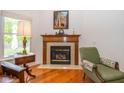 Cozy fireplace with classic mantel, tile surround, and a comfortable seating area in the living room at 16126 Hymera Green, Westfield, IN 46074