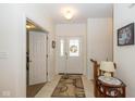 Bright foyer featuring a glass-paneled front door, tiled floors, and a warm, welcoming atmosphere at 16126 Hymera Green, Westfield, IN 46074
