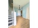 Inviting entryway with beautiful staircase and light hardwood flooring at 1706 Reverend J.T. Menifee St, Anderson, IN 46016