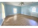 Sunny living room features light blue walls and newer flooring at 1706 Reverend J.T. Menifee St, Anderson, IN 46016