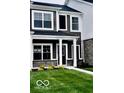 Two-story home features black shutters, a well-maintained lawn, and a front walkway at 19450 Northwest Dr, Westfield, IN 46074