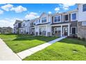 Attractive street view of modern townhomes with sidewalks and lush landscaping at 19450 Northwest Dr, Westfield, IN 46074