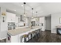 A kitchen with a large island, quartz countertops, stainless steel appliances and hardwood floors at 2447 Stonehaven Dr, Avon, IN 46123