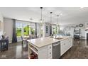 A bright kitchen with a large island flowing into the dining and living room area at 2447 Stonehaven Dr, Avon, IN 46123