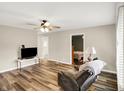 Bright living room with hardwood floors, ceiling fan, and neutral paint at 2538 Sickle Rd, Indianapolis, IN 46219
