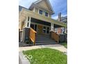 Inviting two-story home showcasing a covered porch and freshly painted exterior at 2936 Guilford Ave, Indianapolis, IN 46205