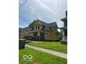 Yellow two-story home with inviting porch and green lawn at 2936 Guilford Ave, Indianapolis, IN 46205