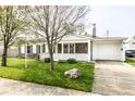 Inviting residence features a charming porch, stone accents, and a well-manicured lawn, set back from the street at 315 Schoolhouse Rd, Franklin, IN 46131