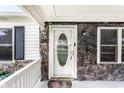 Close-up of the front porch, highlighting the stone detailing, windows, and an inviting front door at 315 Schoolhouse Rd, Franklin, IN 46131