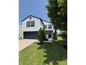 Inviting two-story home with landscaped front yard, featuring a black front door at 3327 Brandenburg Blvd, Indianapolis, IN 46239