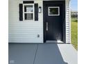 Close-up of front door with black trim, classic window, and gray painted walkway at 3327 Brandenburg Blvd, Indianapolis, IN 46239