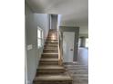 Bright staircase with hardwood steps and floors and light-colored handrail at 3327 Brandenburg Blvd, Indianapolis, IN 46239