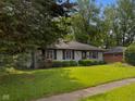 Cozy single-story home with gray siding, black shutters, and well-maintained landscaping at 3627 N Brentwood Ave, Indianapolis, IN 46235