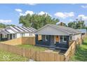 A cozy home offering a fenced front yard, gray brick porch, and a cheerful yellow front door at 3716 W 16Th St, Indianapolis, IN 46222