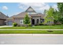Charming single-story home with brick exterior, landscaped yard, and concrete driveway at 4359 Prairie Falcon Dr, Zionsville, IN 46077