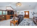 Bright living room with a vaulted ceiling, fireplace, and built-in shelving, plus comfortable seating and a rug at 4399 Summerhaven Dr, New Palestine, IN 46163