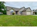 Well-maintained one-story home with green grass and a two-car garage, perfect for suburban living at 4528 Hunt Master Ct, Indianapolis, IN 46268