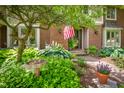 Charming entryway of brick home with landscaped flowerbeds and view of the front door at 5073 St Charles Pl, Carmel, IN 46033
