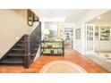 Inviting foyer features a staircase, hardwood floors, and a view into the living room at 5073 St Charles Pl, Carmel, IN 46033