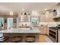 Well-lit kitchen featuring granite countertops, stainless steel appliances and light wood cabinetry at 5251 Apache Moon, Carmel, IN 46033