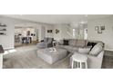 Open-concept living room boasting plush gray furniture, carpet floors, and multiple entries at 7319 Farlin Dr, Whitestown, IN 46075